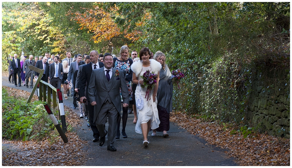 The Bride and Groom lead guests along a country lane from church to the reception.